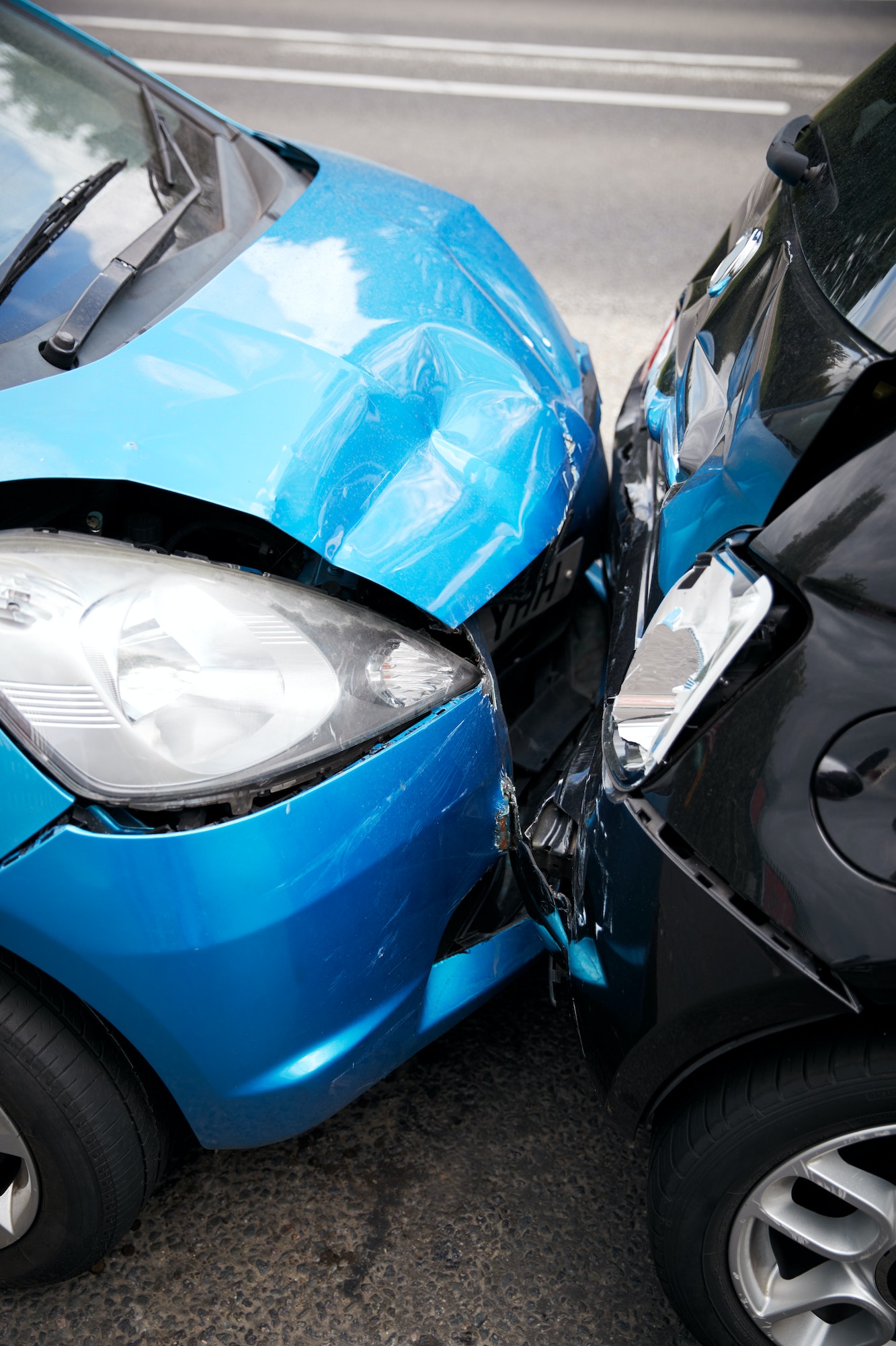 Close Up Of Two Cars Damaged In Road Traffic Accident