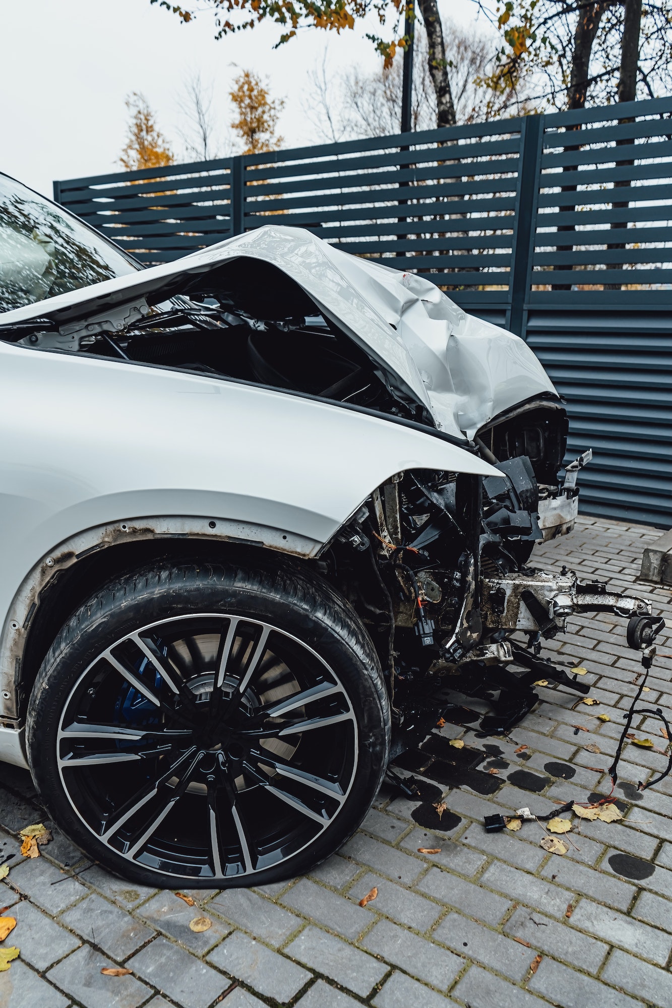Total accident of a white car after hitting a lamppost. Frontal collision. Deployed airbags during