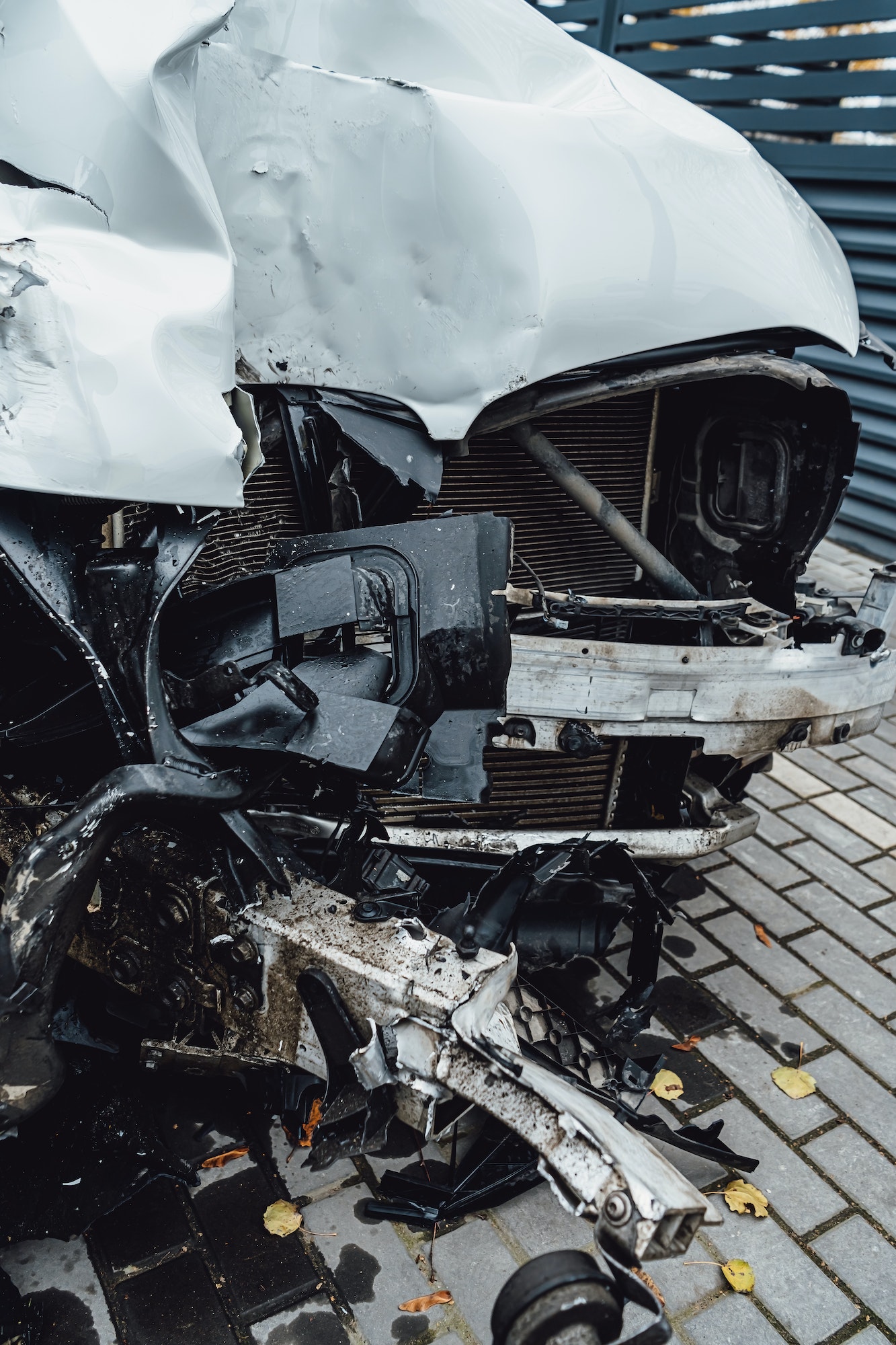 Total accident of a white car after hitting a lamppost. Frontal collision. Deployed airbags during