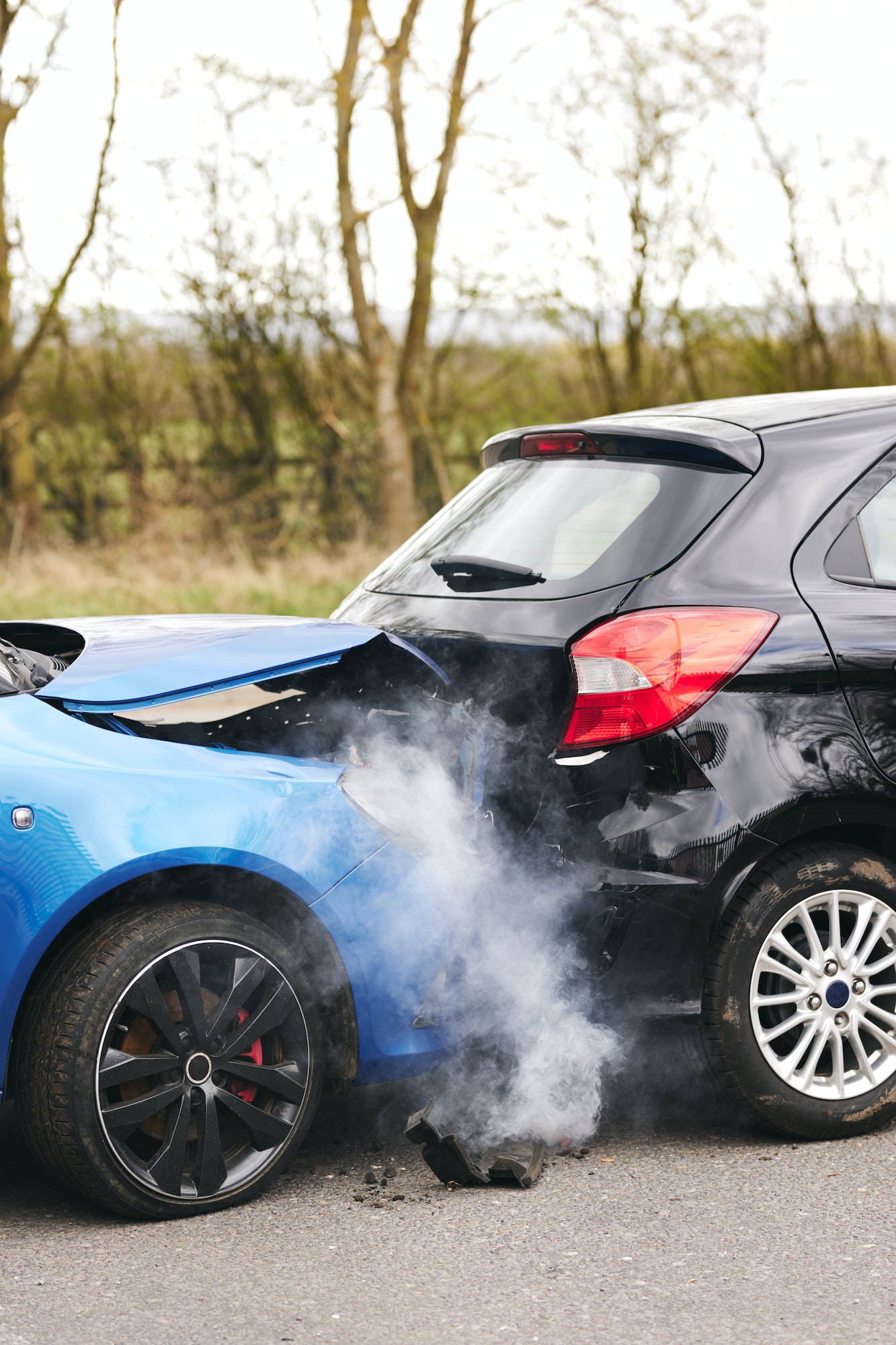 Two Damaged Cars Involved In Road Traffic Accident Showing Smoke After Collision